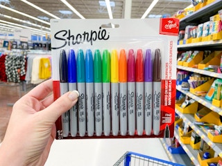 hand holding pack of sharpies inside Walmart