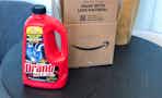 a bottle of Drano sitting in front of an Amazon box 