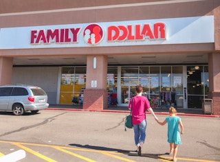 Two people walking into a Family Dollar store