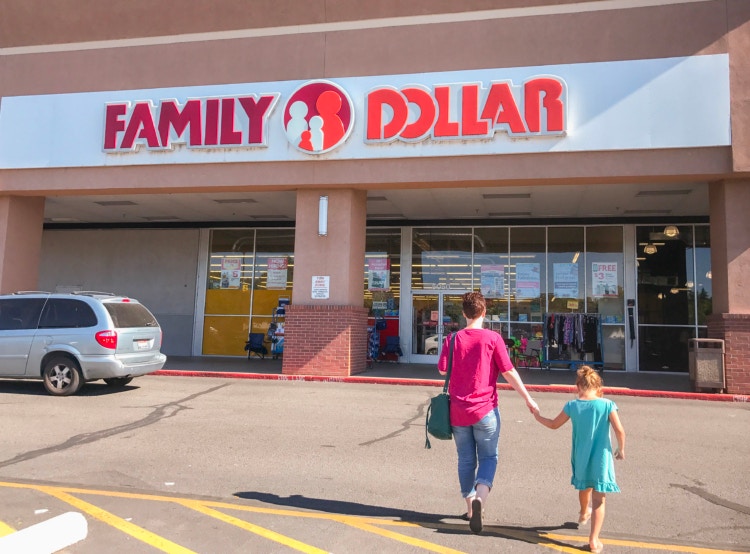 Two people walking into a Family Dollar store