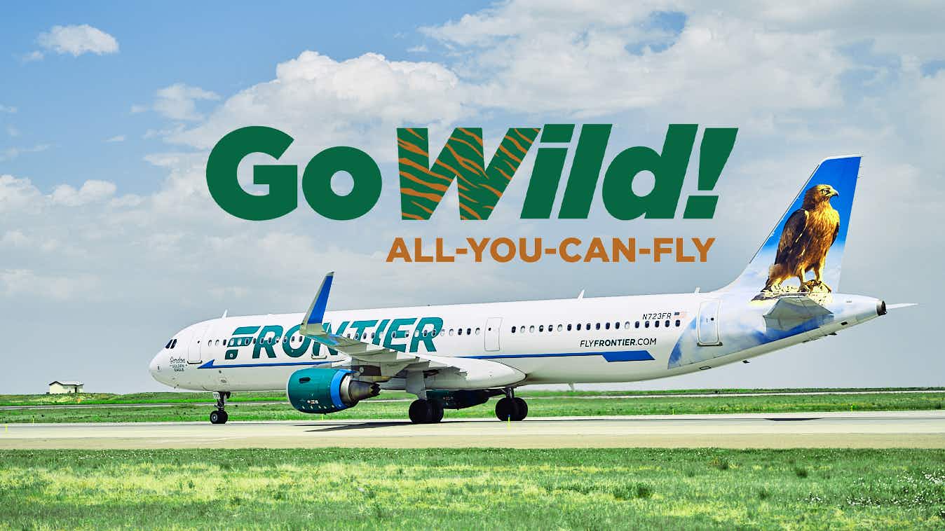 A Frontier Airlines plane on a tarmac with the GoWild All-You-Can-Fly pass logo above it