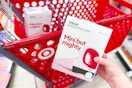 hand holding a cricut easy press mini in front of a target cart