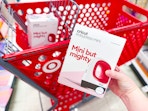 hand holding a cricut easypress mini in front of a target cart