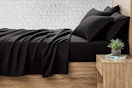 Lifestyle image of the black king 6 piece sheet set from Serta So Soft (online at Walmart)