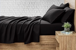 Lifestyle image of the black king 6 piece sheet set from Serta So Soft (online at Walmart)