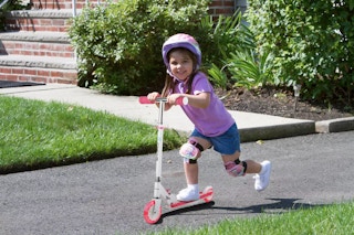 girl riding scooter outside