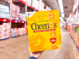 hand holding me a box of general mills cereal