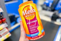 hand holding a container of Metamucil