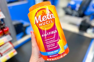 hand holding a container of Metamucil