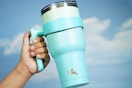 a woman holding a tumbler