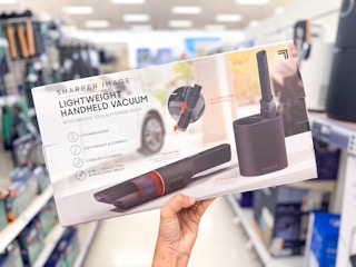 hand holding a sharper image hand vac in a target aisle
