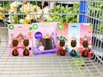 3 Air Wick Products in Walmart shopping cart in front of flowers