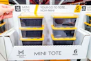 hand holding a pack of members mark mini totes