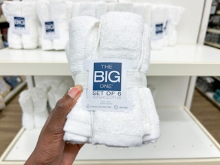 the big one washcloth 6 pack being held in front of shelf