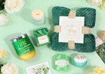 a green-themed spa gift set on a mint green background with flowers