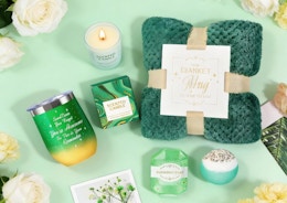 a green-themed spa gift set on a mint green background with flowers