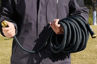 a man holding a garden hose