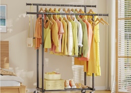 a clothing rack with clothes and shoes on it