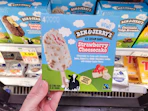 hand holding a box of ben jerry ice cream bars