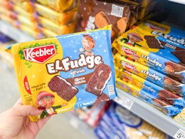 hand holding a pack of el fudge cookies in front of others on walmart shelf