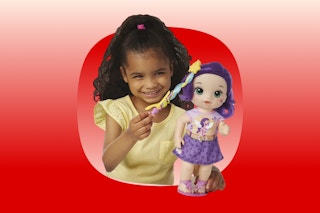 Girl playing with My Little Pony Baby Alive doll (playing with her hair)