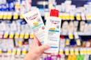 person holding 2 bottles of eucerin lotion
