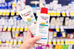 person holding 2 bottles of eucerin lotion