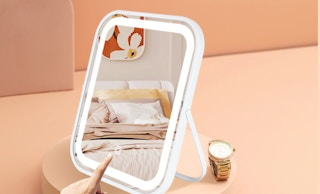 a LED vanity mirror on a peach-colored display