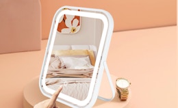 a LED vanity mirror on a peach-colored display