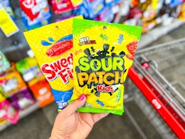 hand holding swedish fish and sour patch kids candy