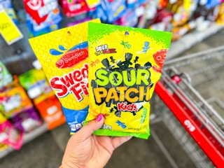 hand holding swedish fish and sour patch kids candy