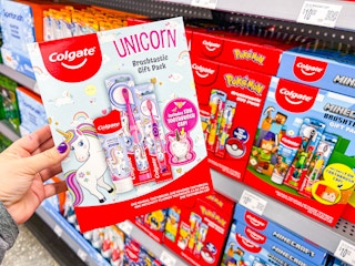hand holding colgate kids gift set in walmart aisle