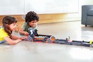Lifestyle image of the Hot Wheels RacerVerse Batman’s Escape Chase Track Set being played with by 2 children