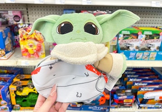 hand holding grogu plush