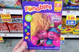 hand holding a box of funables fruit snacks at kroger