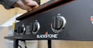Someone cleaning a Blackstone griddle
