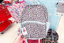 hand grabbing a dealworthy backpack off a target shelf