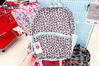 hand grabbing a dealworthy backpack off a target shelf