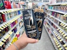hand holding l'oreal elvive shampoo in walgreens