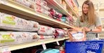 person looking in the dog food aisle
