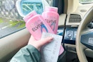 hand holding l'oreal elvive shampoo and a receipt in a car