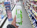 hand holding dove plant milk body wash in walgreens