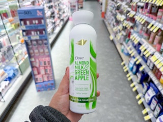 hand holding dove plant milk body wash in walgreens