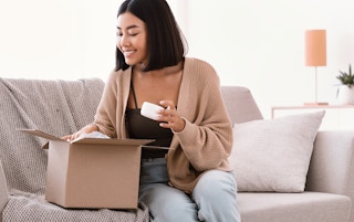 Influencer opening a box of beauty products