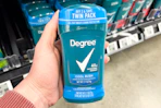 hand holding degree deodorant in walmart aisle