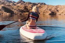 a woman on an inflatable paddle board