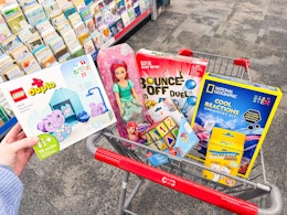 toys in a cart including lego duplo, barbie, national geographic, bounce-off and more