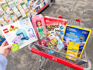 toys in a cart including lego duplo, barbie, national geographic, bounce-off and more