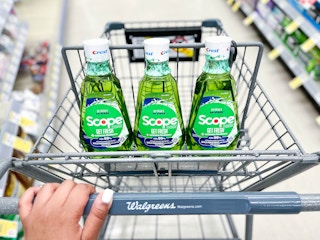 hand pushing cart with three bottles of Scope Get Fresh mouthwash inside