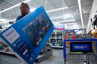 a woman shopping tvs at walmart 